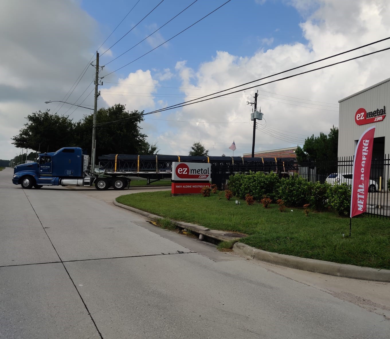 ezMetal facility entrance with branded signs and a freight truck