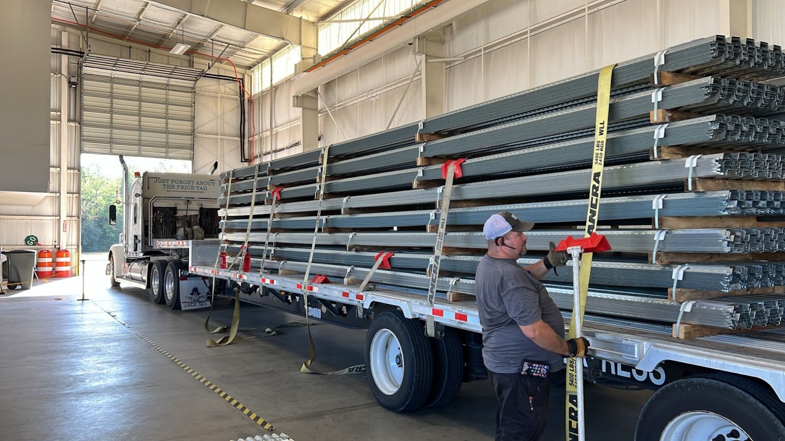 ezMetal crew loading steel deck bundles onto a flatbed truck