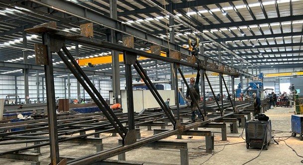 Steel columns and beams being fabricated inside the manufacturing plant