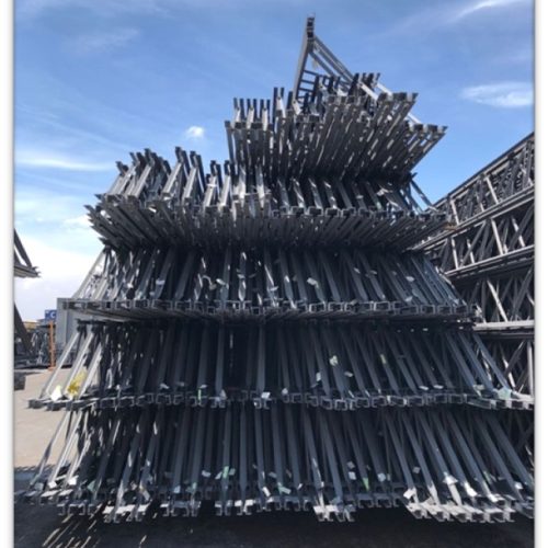 Open web steel joists stacked vertically in the fabrication yard